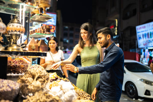 Salesman talking and selling ingredients to tourists in a street market