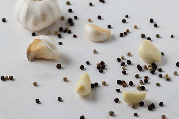 natural healthy garlic on white wooden table with condiments