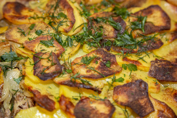 The meat is baked with onions and potatoes in a faience bowl. French cuisine