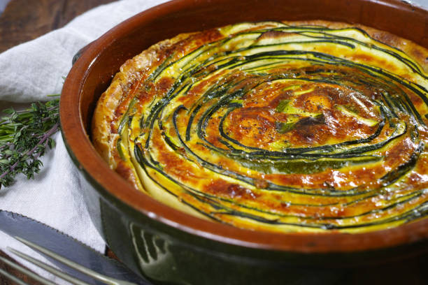 Homemade traditional quiche vegetable pie with green courgette and carrot