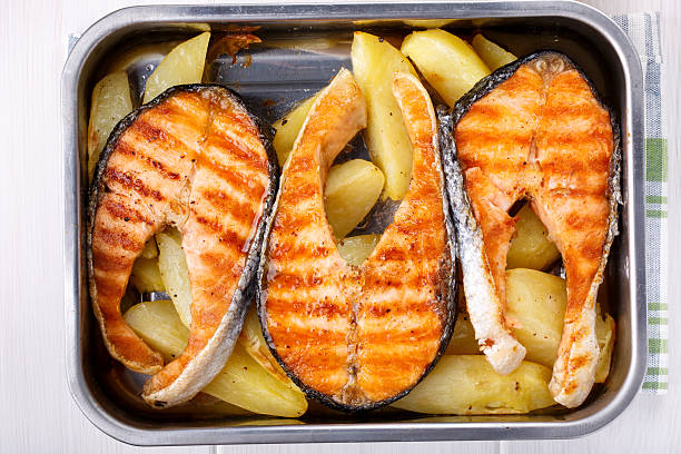 Grilled salmon steak with potatoes. Top view.