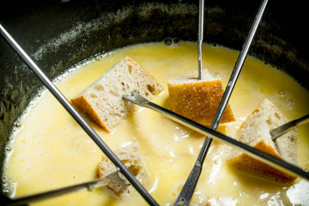 Delicious fondue cheese with slices of bread . top view