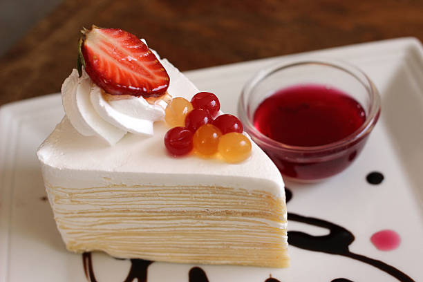 strawberry and cream - crepe cake and sauce on white dish