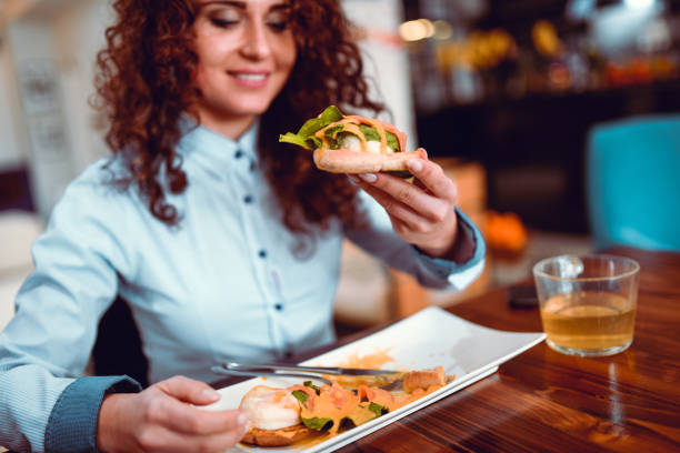 Cute Female  Eating Lunch In Restaurant