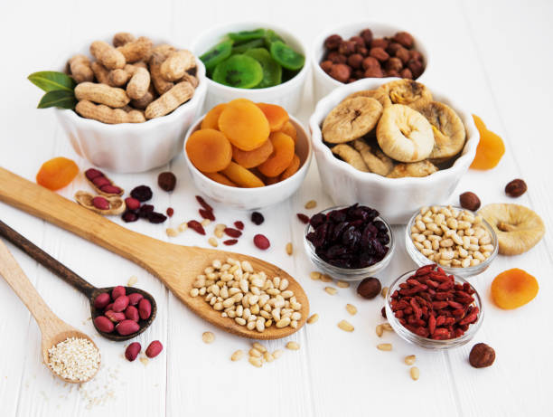 Mixed dried fruits on a old white wooden table